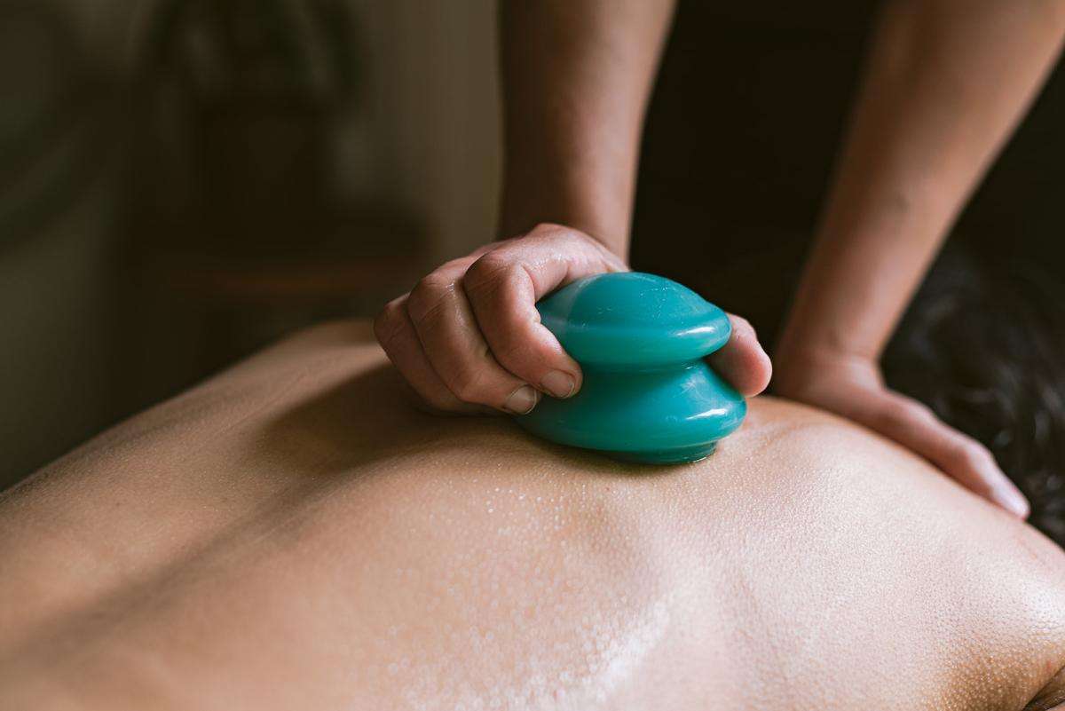 A woman receiving a cupping therapy service