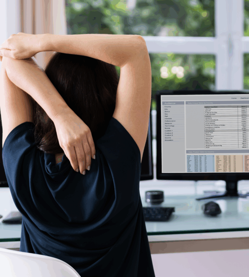 An Employee stretching her back in an Office