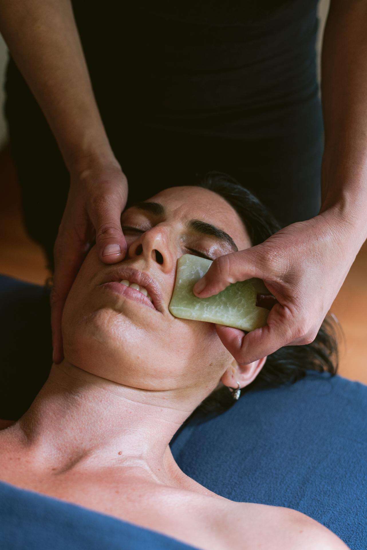 Becky Pilon- Mobile Service A woman receiving Body Gua Sha therapy at home