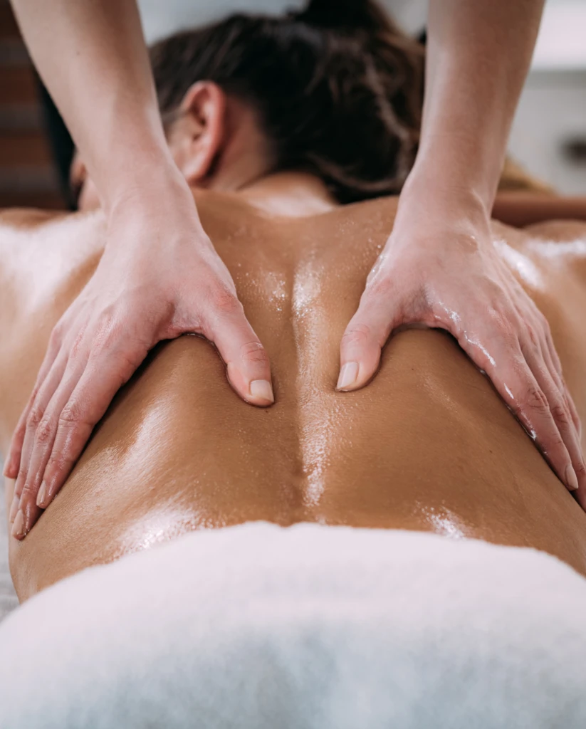 A woman receives a back massage from Beky